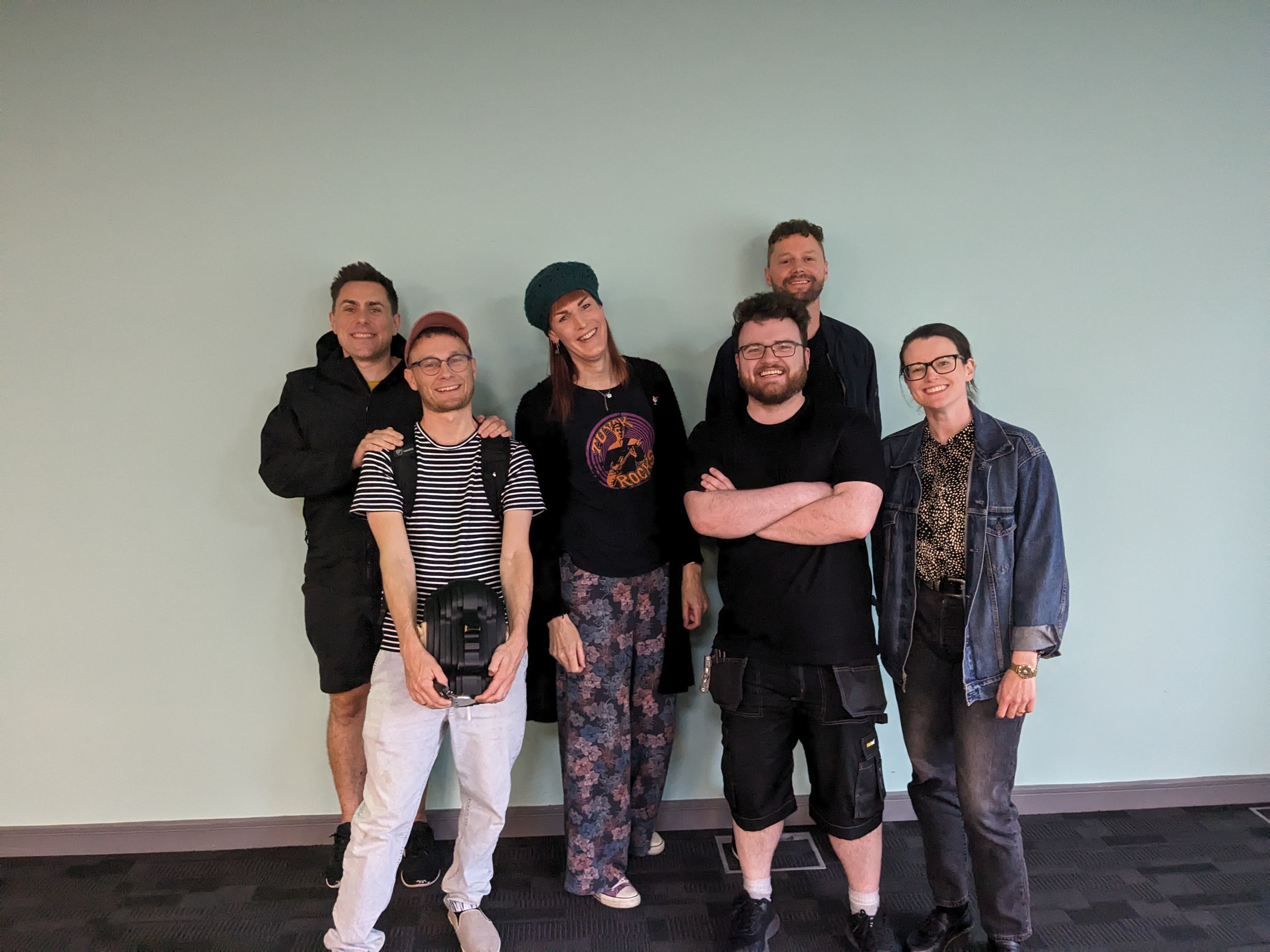 Six people gathered for a group photograph
