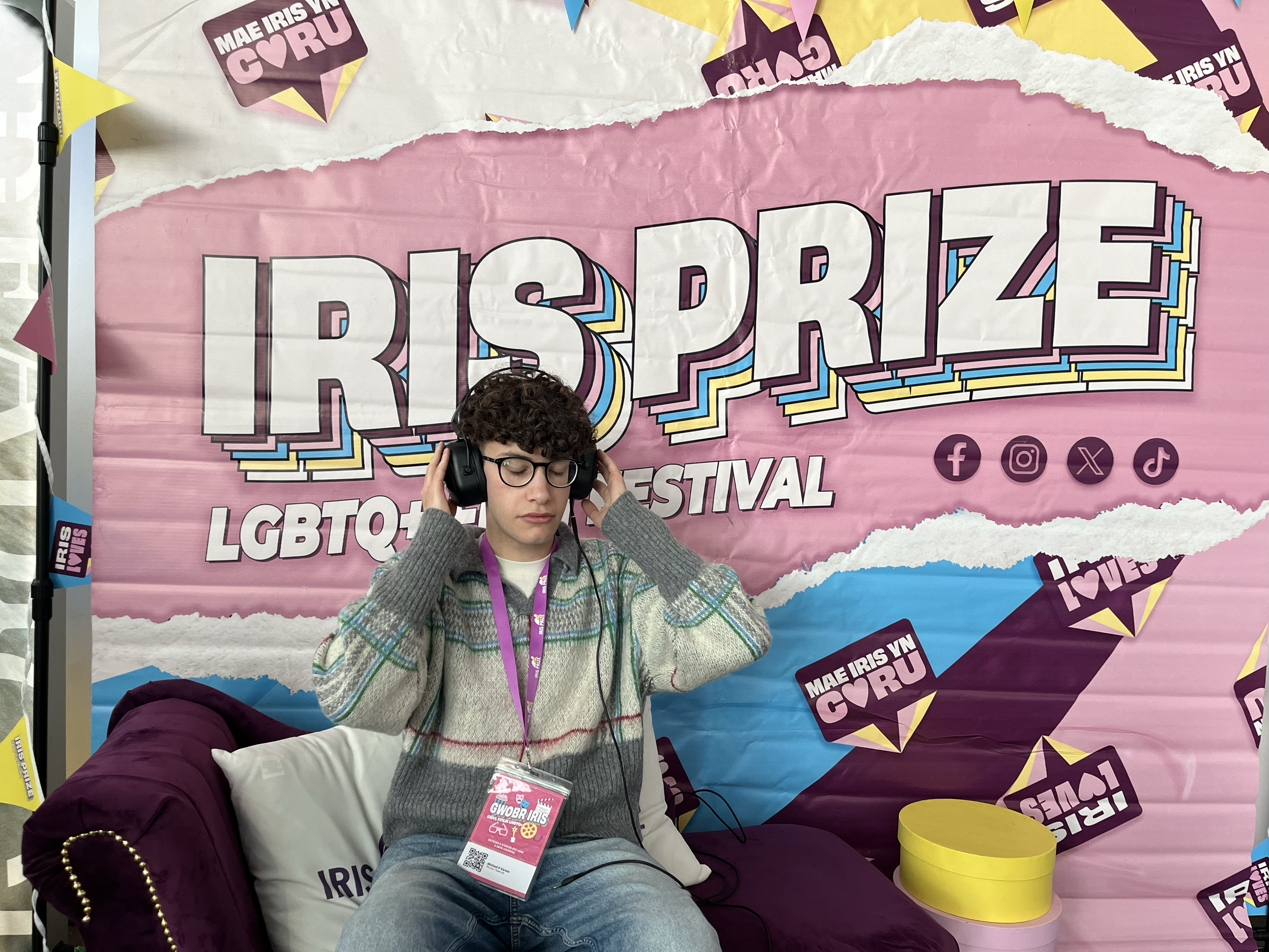 A person listening on headphones at Iris Prize